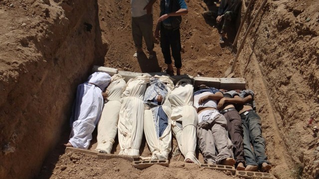 This image provided by by Shaam News Network on Thursday, Aug. 22, 2013, purports to show several bodies being buried in a suburb of Damascus, Syria during a funeral on Wednesday, Aug. 21, 2013, following allegations of a chemical weapons attack that reportedly killed 355 people. (AP Photo/Shaam News Network)